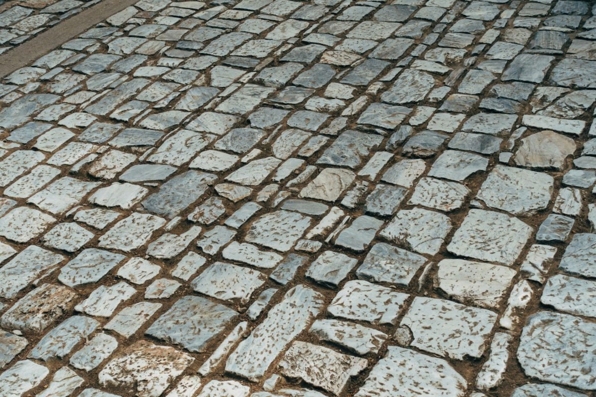 Grey cobblestone paving laid in a traditional pattern
