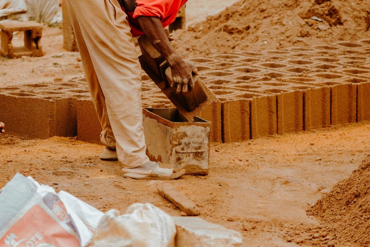 Worker forming a concrete unit in a mould at a production yard