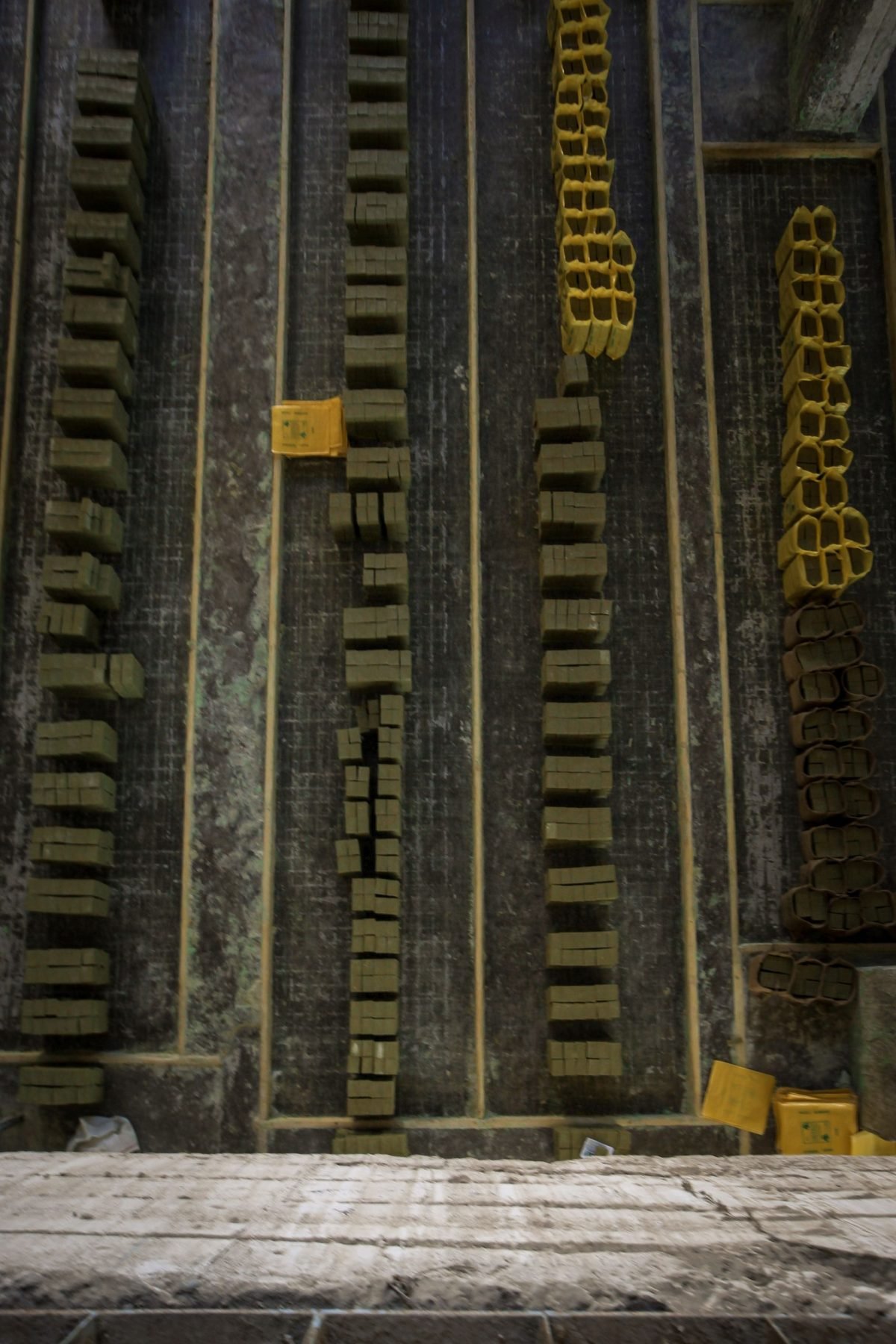 Cast pavers stacked in neat rows on a production floor